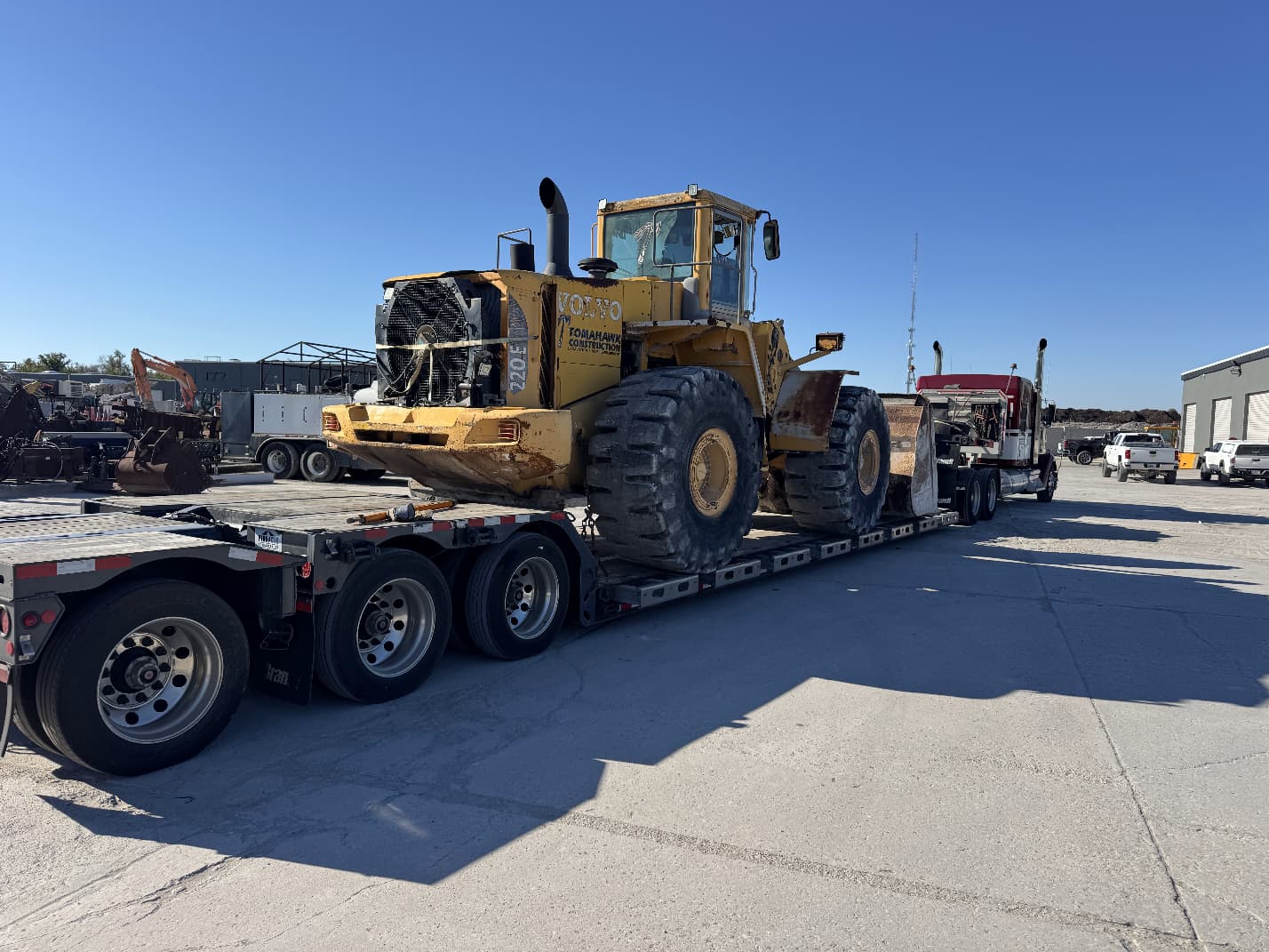 Volvo wheel loader secured on lowboy trailer for heavy haul transport